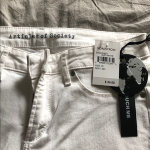 Women’s size 28 white articles of society jeans.